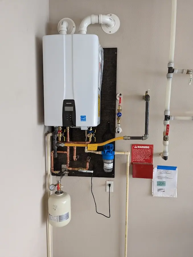 Professional plumber installing copper piping in a Green Oaks home